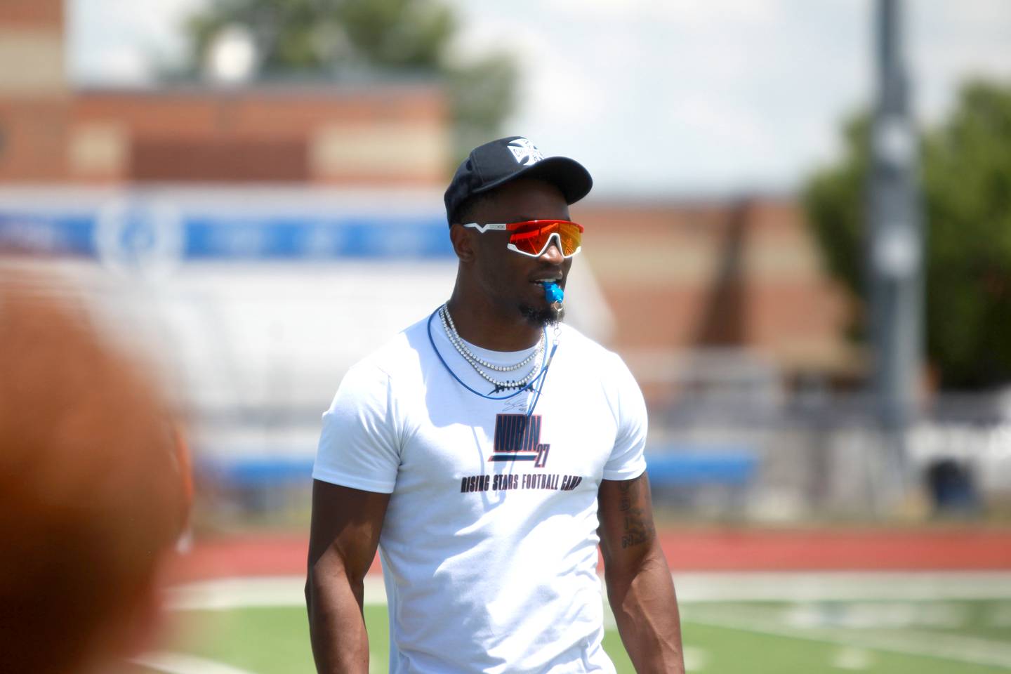 Former St. Charles North standout and current New York Giants defensive back Tyler Nubin works with young players on the first day of a three-day football camp on Friday, June 20, 2025 in St. Charles.