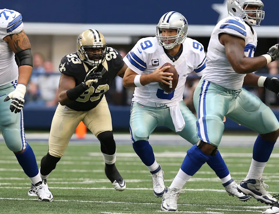 Dec 23, 2012; Dallas Cowboys quarterback Tony Romo (9) is sacked by New Orleans Saints defensive end Junior Galette (93). Mandatory Credit: Matthew Emmons-Imagn Images