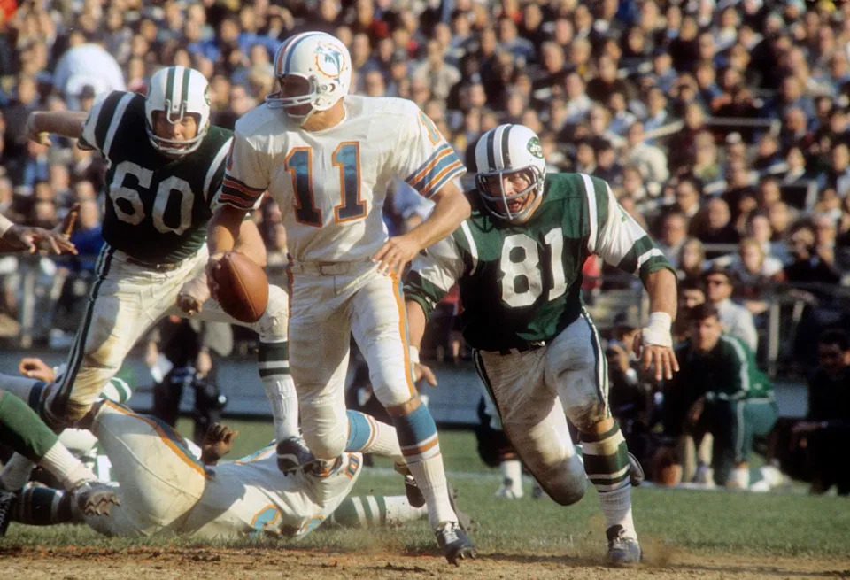 Gerry Philbin #81 of the New York Jets pursues quarterback Rick Norton #11 of the Miami Dolphins during an AFL football game at Shea Stadium. Getty Images