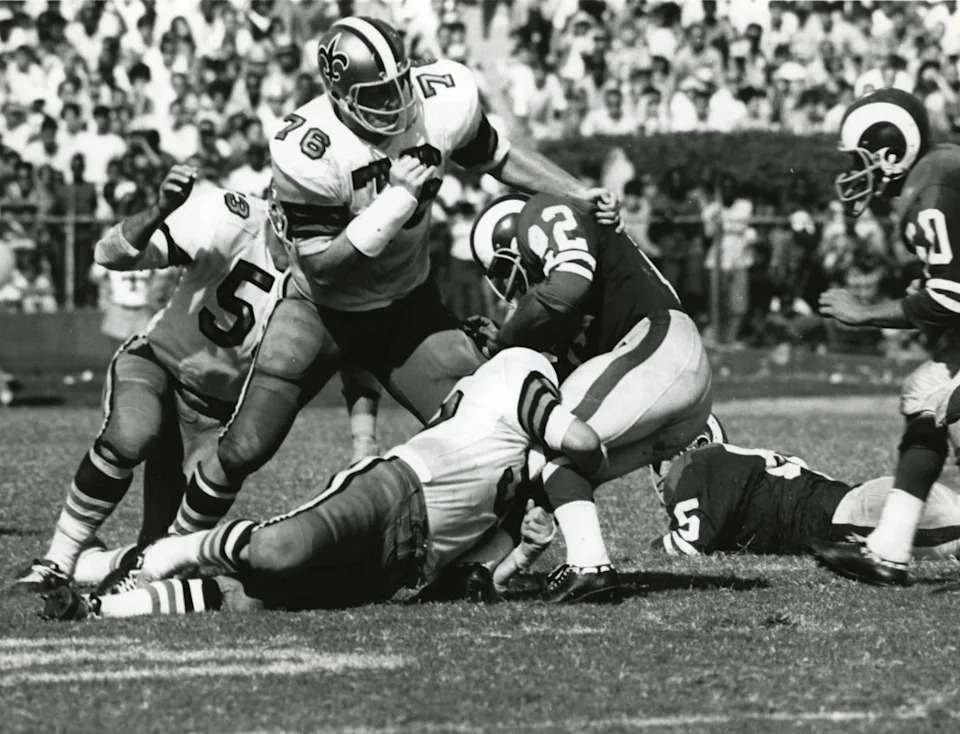 Sep 17, 1967; FILE PHOTO; New Orleans Saints defensive tackle Dave Rowe (76) and linebacker Dave Simmons (53) tackle Los Angeles Rams running back Dick Bass (42). Mandatory Credit: Malcolm Emmons- Imagn Images