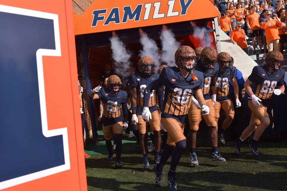 Oct 19, 2024; Champaign, Illinois, USA; Illinois Fighting Illini players take the field before a game against the Michigan Wolverines at Memorial Stadium. Mandatory Credit: Ron Johnson-Imagn Images