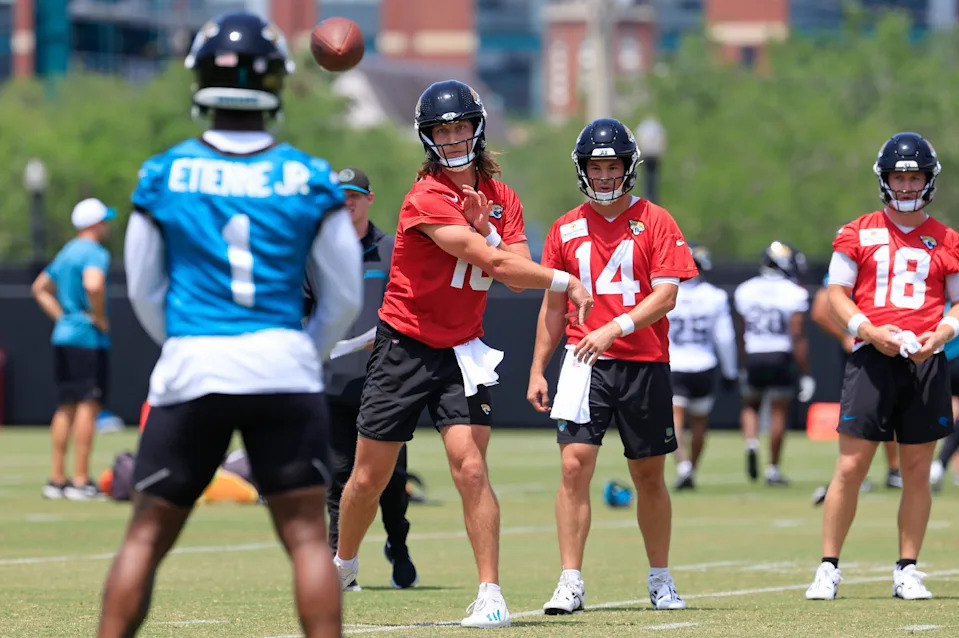 Jacksonville Jaguars quarterback Trevor Lawrence (16) throws the ball to running back Travis Etienne Jr. (1) during the first organized team activity at Miller Electric Center Monday, May 19, 2025 in Jacksonville, Fla.