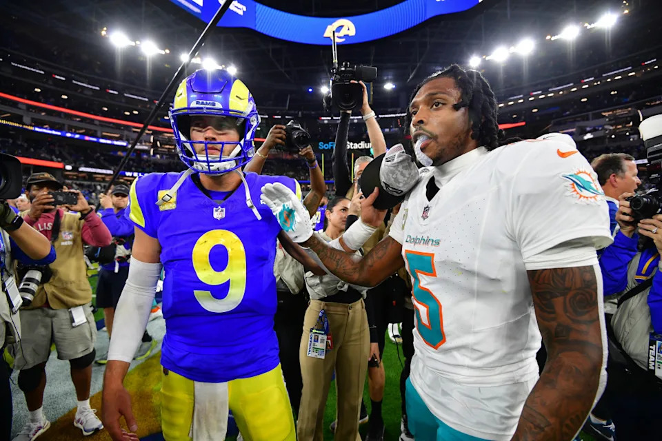 Los Angeles Rams quarterback Matthew Stafford meets with Miami Dolphins cornerback Jalen Ramsey. Gary A. Vasquez-Imagn Images