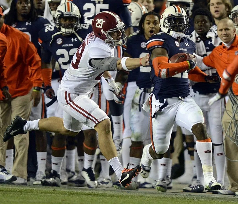 Alabama wide receiver Caleb Sims (29) grabs for Auburn cornerback Chris Davis (11) during the "Kick Six" play in 2013Amanda Sowards&sol;Advertiser