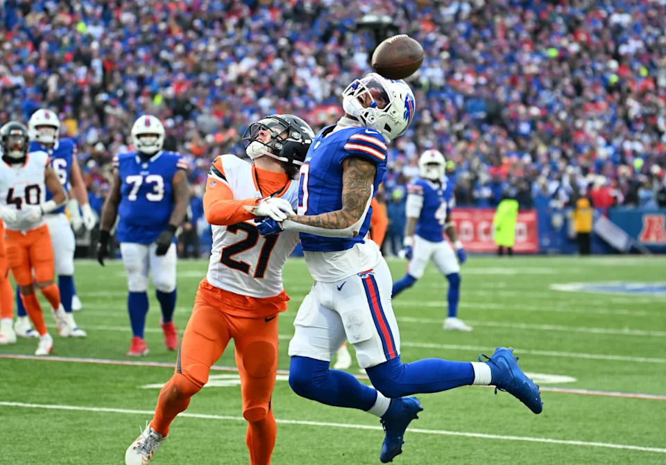 Buffalo Bills wide receiver Keon Coleman (0) and Denver Broncos cornerback Riley Moss (21) look for a pass in an AFC wild card game.Mark Konezny-Imagn Images