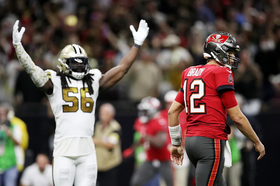 NEW ORLEANS, LOUISIANA - OCTOBER 31: Tom Brady #12 of the Tampa Bay Buccaneers and Demario Davis #56 of the New Orleans Saints react after Brady throws an interception returned for a touchdown during the fourth quarter against the New Orleans Saints at Caesars Superdome on October 31, 2021 in New Orleans, Louisiana. (Photo by Sean Gardner/Getty Images)