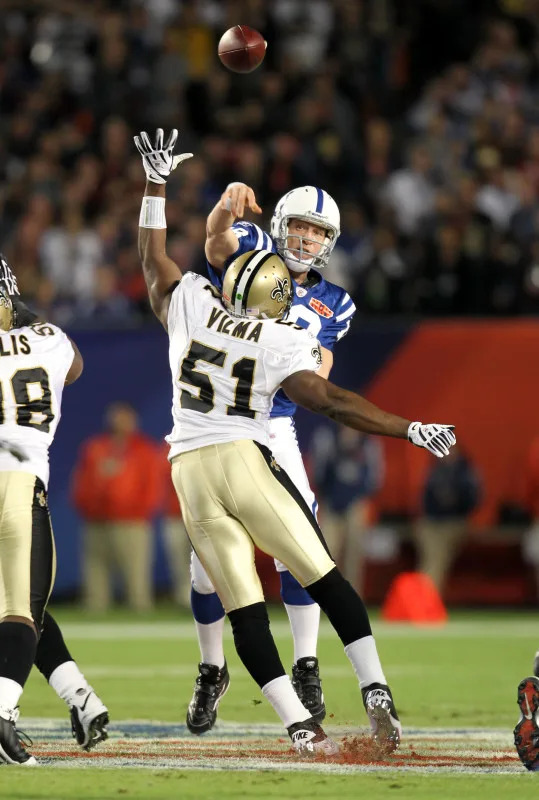 Feb 7, 2010; Indianapolis Colts quarterback Peyton Manning (18) throws under pressure from the New Orleans Saints linebacker Jonathan Vilma (51) during Super Bowl XLIV. Mandatory Credit: Matthew Emmons-Imagn Images