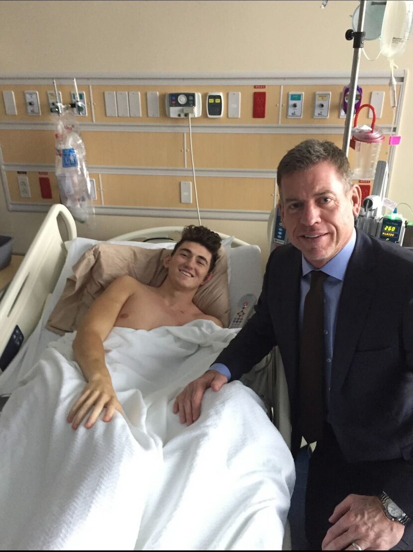 Former Cowboys quarterback Troy Aikman visits Luke Laufenberg during one of his hospital...