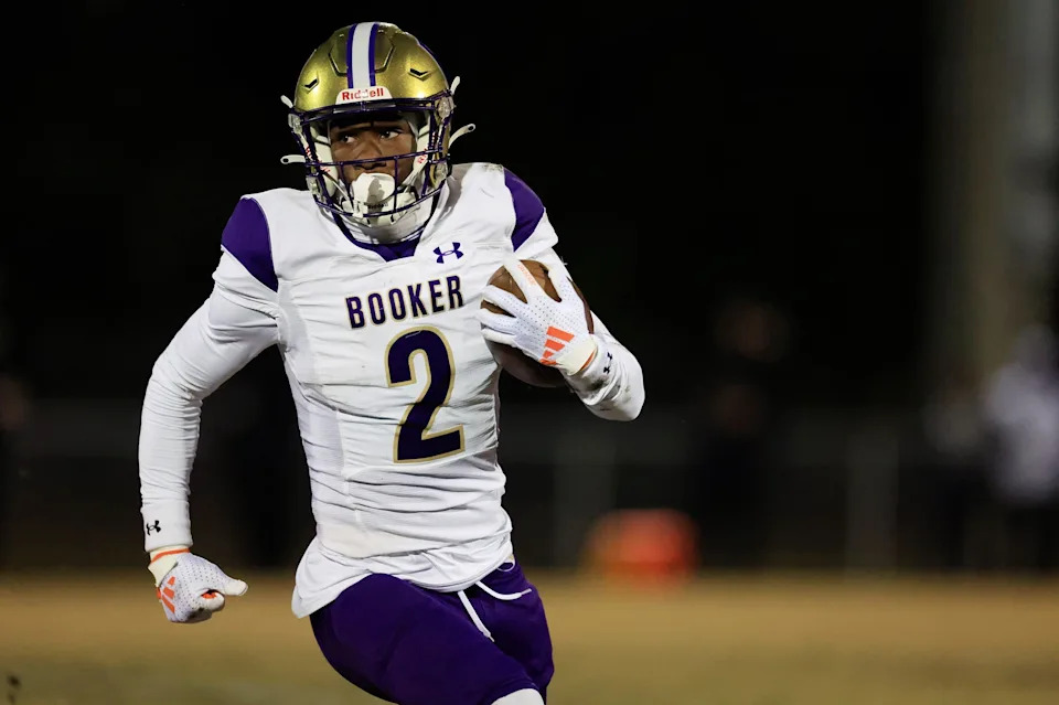 Booker's Tyren Wortham rushes for yards during the first quarter of an FHSAA Class 3A state football semifinal matchup Friday, Dec. 6, 2024 at Raines High School in Jacksonville, Fla.