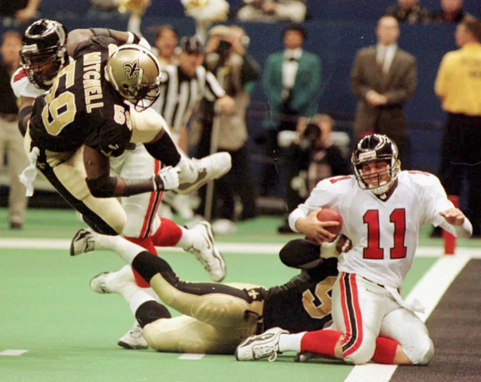 CORRECTED VERSION: Atlanta Falcons quarterback Doug Johnson (11) is sacked by New Orleans defensive end Willie Whitehead (C) on the one yard line during the first quarter in New Orleans December 17, 2000. New Orleans linebacker Keith Mitchell (59) is sent flying on a block by an unidentified Atlanta player. The Saints won 23-7, clinching a playoff berth, their first since 1992.
DRM