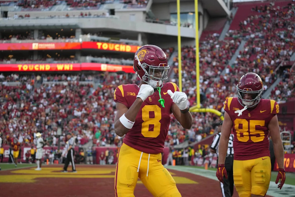 Nov 30, 2024; Los Angeles, California, USA; Southern California Trojans wide receiver Ja'Kobi Lane (8) celebrates with tight end Walker Lyons (85) after scoring on a 6-yard touchdown reception against the Notre Dame Fighting Irish in the second half at United Airlines Field at Los Angeles Memorial Coliseum. © Kirby Lee-Imagn Images