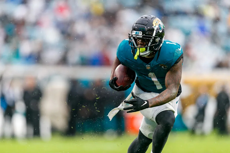 Jacksonville Jaguars running back Travis Etienne Jr. (1) runs the ball against the Tennessee Titans during the second quarter at EverBank Stadium.Morgan Tencza-Imagn Images