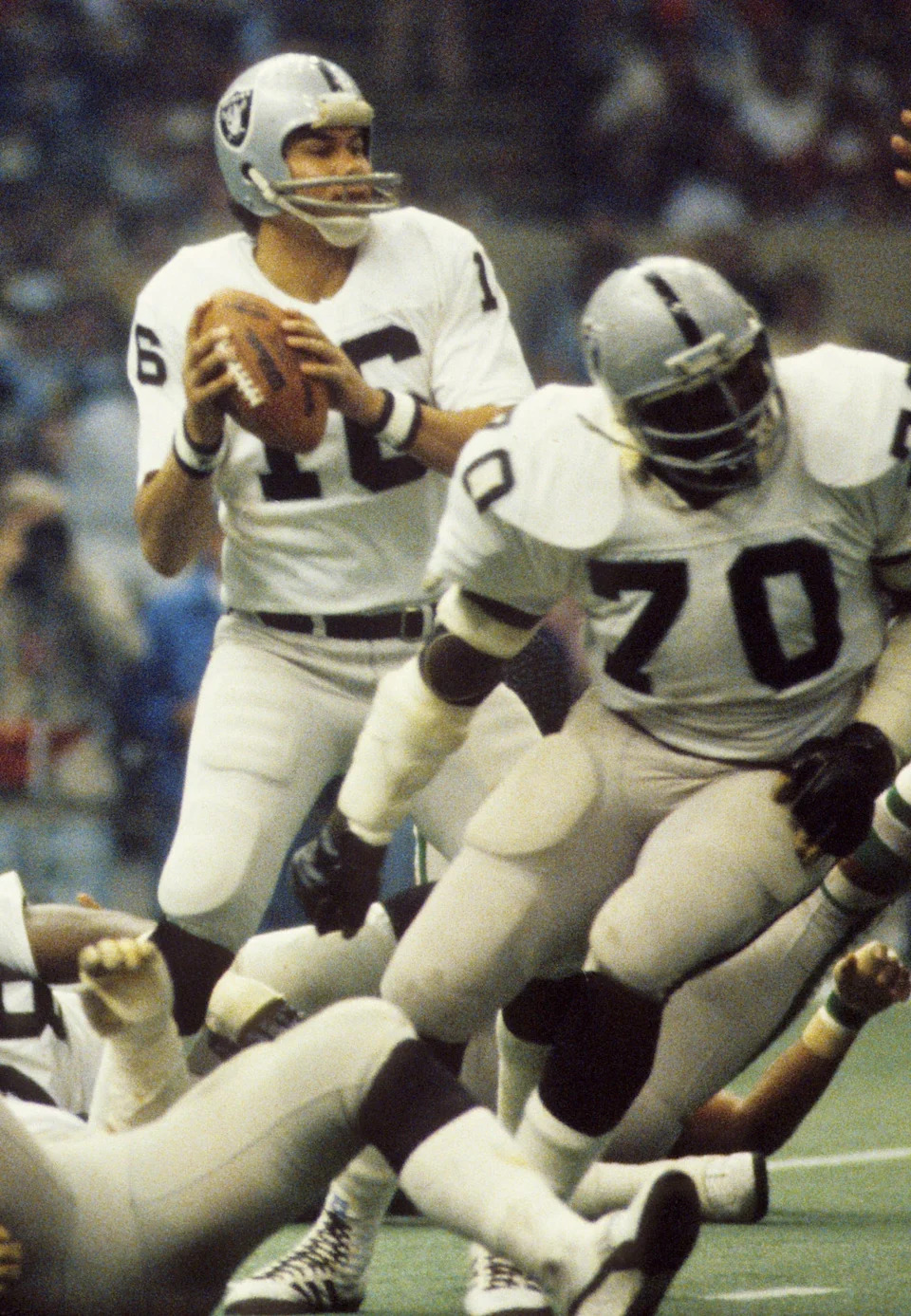Jan 25, 1981; New Orleans, LA, USA; FILE PHOTO; Oakland Raiders quarterback Jim Plunkett (16) in action with offensive lineman Henry Lawrence (70) against the Philadelphia Eagles during Super Bowl XV at the Superdome. The Raiders defeated the Eagles 27-10. Mandatory Credit: Manny Rubio-USA TODAY Sports