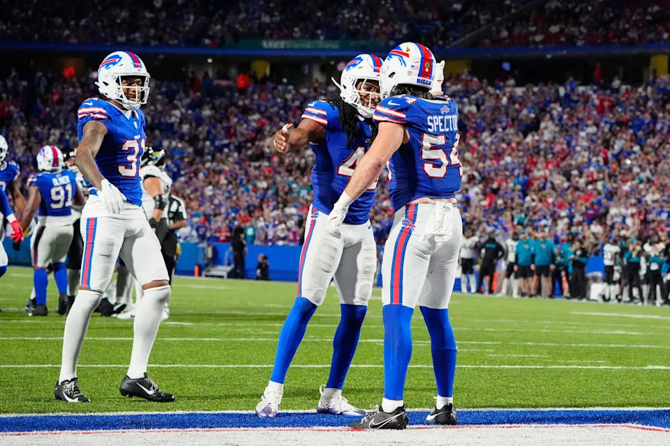 Sep 23, 2024; Orchard Park, New York, USA; Buffalo Bills linebacker Dorian Williams (42) congratulates linebacker Baylon Spector (54) for breaking up a pass against the Jacksonville Jaguars during the second half at Highmark Stadium. Mandatory Credit: Gregory Fisher-Imagn Images