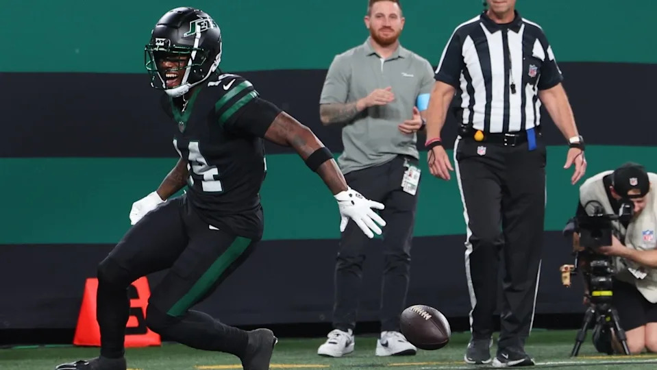 Oct 31, 2024; East Rutherford, New Jersey, USA; New York Jets wide receiver Malachi Corley (14) drops the ball prior to crossing the goal line against the Houston Texans during the first half at MetLife Stadium. 