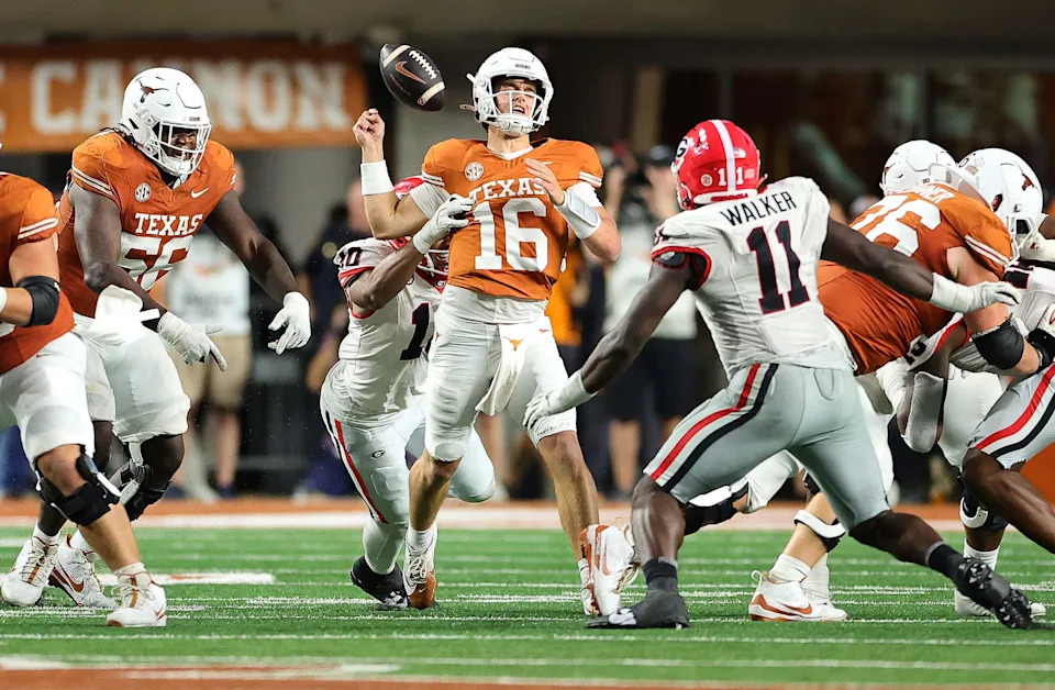 Arch Manning #16 of the Texas Longhorns fumbles the ball as he is hit by Damon Wilson II #10 of the Georgia Bulldogs
