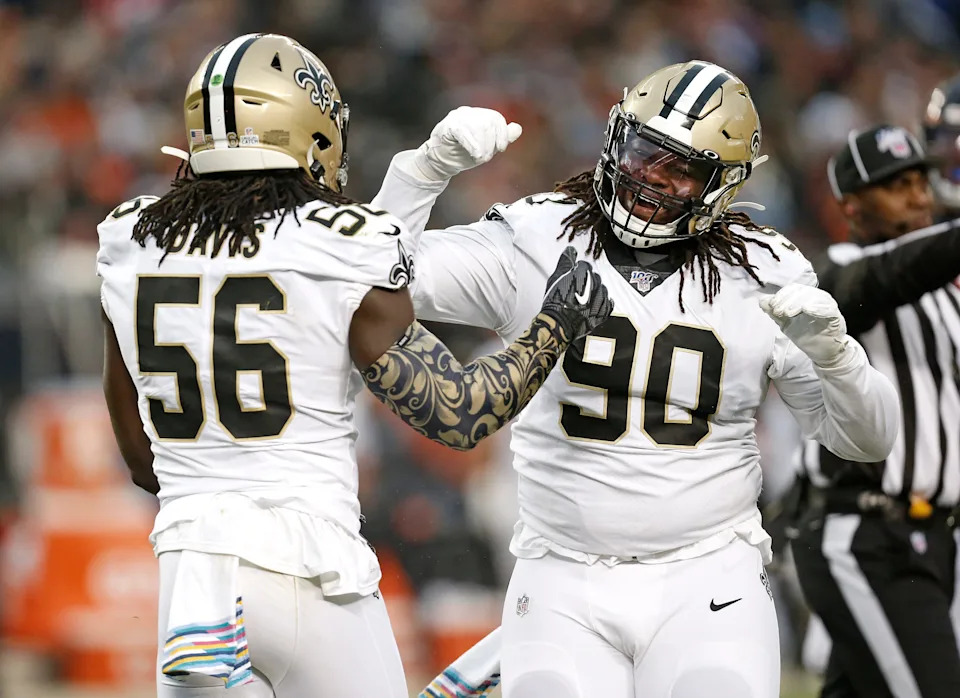 CHICAGO, ILLINOIS - OCTOBER 20: Demario Davis #56 of the New Orleans Saints is congratulated by Malcom Brown #90 after a play during the second half against the Chicago Bears at Soldier Field on October 20, 2019 in Chicago, Illinois. (Photo by Nuccio DiNuzzo/Getty Images)