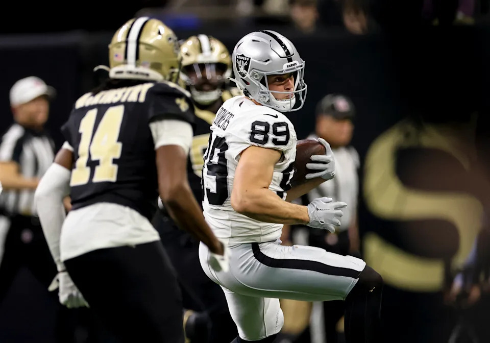 NEW ORLEANS, LOUISIANA - DECEMBER 29: Brock Bowers #89 of the Las Vegas Raiders catches a pass as Kool-Aid McKinstry #14 of the New Orleans Saints defends during the first half of a game at the Caesars Superdome on December 29, 2024 in New Orleans, Louisiana. (Photo by Derick E. Hingle/Getty Images)