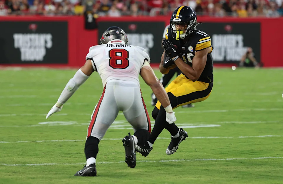 Aug 11, 2023; Tampa, Florida, USA; Pittsburgh Steelers wide receiver Cody White (15) runs with the ball as Tampa Bay Buccaneers linebacker SirVocea Dennis (8) defends during the first half at Raymond James Stadium. Mandatory Credit: Kim Klement Neitzel-USA TODAY Sports