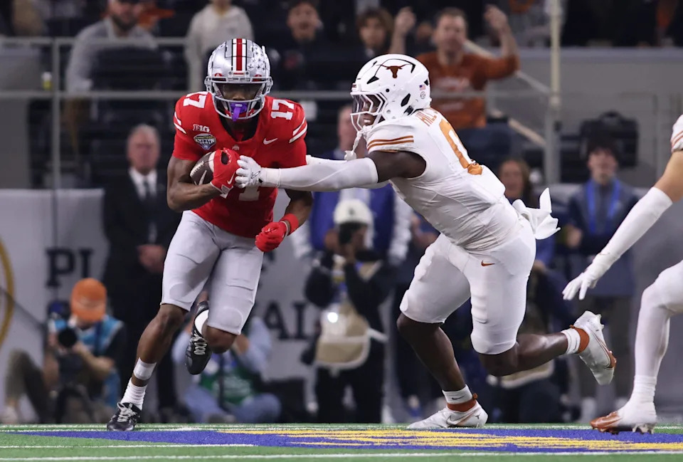 Jan 10, 2025; Arlington, Texas, USA; Ohio State Buckeyes wide receiver Carnell Tate (17) runs against Texas Longhorns linebacker Anthony Hill Jr. (0) during the first quarter of the College Football Playoff semifinal in the Cotton Bowl at AT&T Stadium. Mandatory Credit: Tim Heitman-Imagn Images