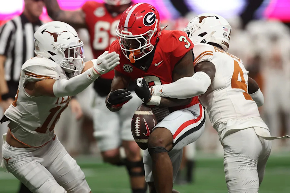 Dec 7, 2024; Atlanta, GA, USA; Georgia Bulldogs running back Nate Frazier (3) fumbles the ball against Texas Longhorns defensive back Andrew Mukuba (4) during the second half in the 2024 SEC Championship game at Mercedes-Benz Stadium. Mandatory Credit: Brett Davis-Imagn Images
