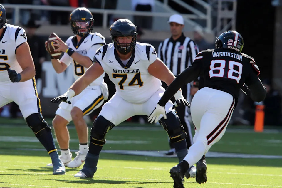 Nov 30, 2024; Lubbock, Texas, USA; West Virginia Mountaineers offensive lineman Wyatt Milum (74) prepares to block Texas Tech Red Raiders back Amier Washington (88) in the first half at Jones AT&T Stadium and Cody Campbell Field. Mandatory Credit: Michael C. Johnson-Imagn ImagesMichael C. Johnson-Imagn Images