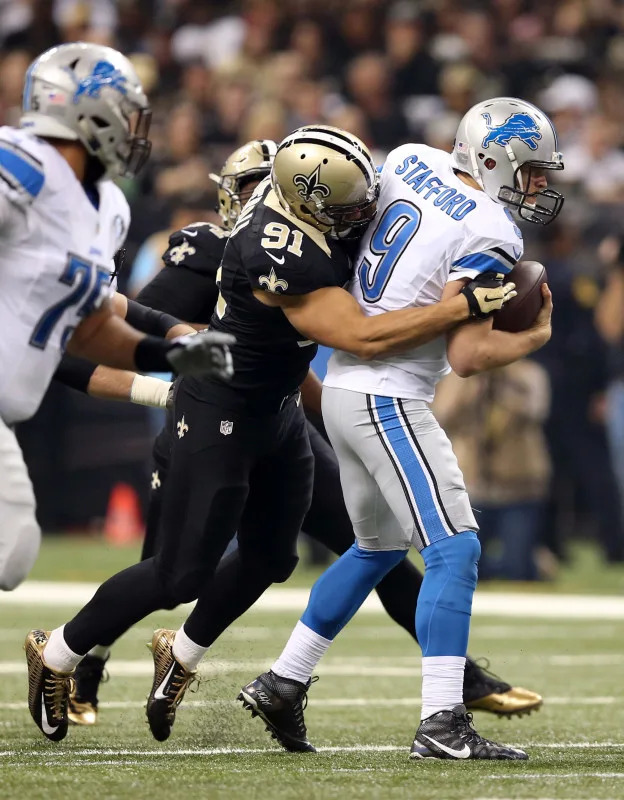 Dec 21, 2015; Detroit Lions quarterback Matthew Stafford (9) is sacked by New Orleans Saints linebacker Kasim Edebali (91). Mandatory Credit: Chuck Cook-Imagn Images