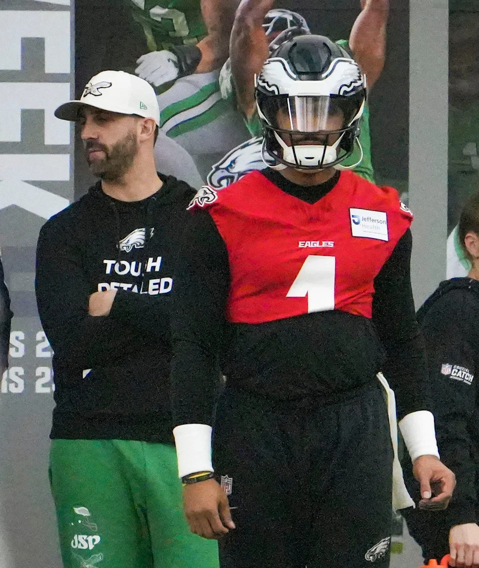 Eagles head coach Nick Sirianni (left) watches his players as quarterback Jalen Hurts takes part in drills as the Philadelphia Eagles work out in preparation for the Super Bowl at the NovaCare Complex in Philadelphia, Pa. Friday, Jan. 31, 2025.