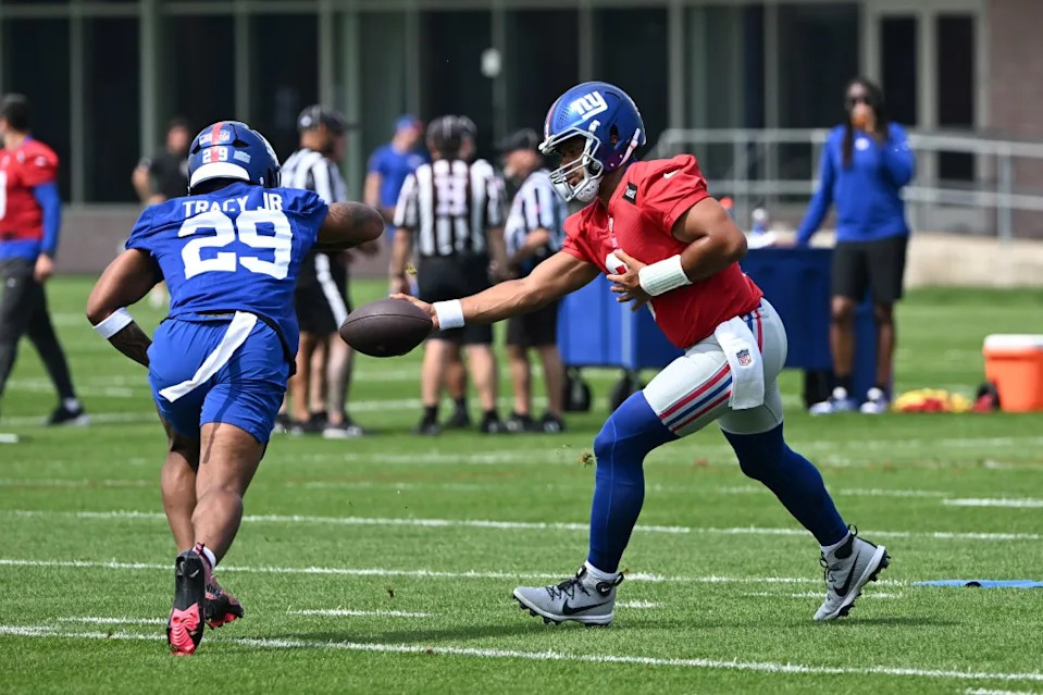 Russell Wilson (3) hands off the ball to Giants running back Tyrone Tracy Jr. (29) during practice during OTAs in East Rutherford, N.J. Bill Kostroun/New York Post