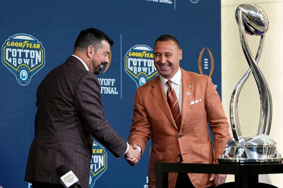 Ohio State Buckeyes head coach Ryan Day and Texas Longhorns head coach Steve Sarkisian shake hands prior to the College Football Playoff semifinal.Adam Cairns/Columbus Dispatch / USA TODAY NETWORK via Imagn Images