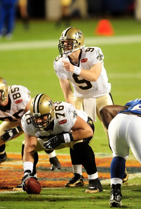 Feb 7, 2010; New Orleans Saints quarterback Drew Brees (9) prepares to take the snap from center Jonathan Goodwin (76) during Super Bowl XLIV against the Indianapolis Colts. Mandatory Credit: Mark J. Rebilas-Imagn Images