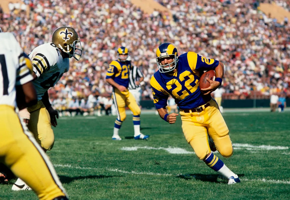 Sep 22, 1974; Los Angeles, CA, USA; FILE PHOTO; Los Angeles Rams running back John Cappelletti (22) carries the ball around New Orleans Saints defensive end Bob Pollard (82) at the Coliseum. The Rams defeated the Saints 24-0. Mandatory Credit: Darryl Norenberg-USA TODAY Sports