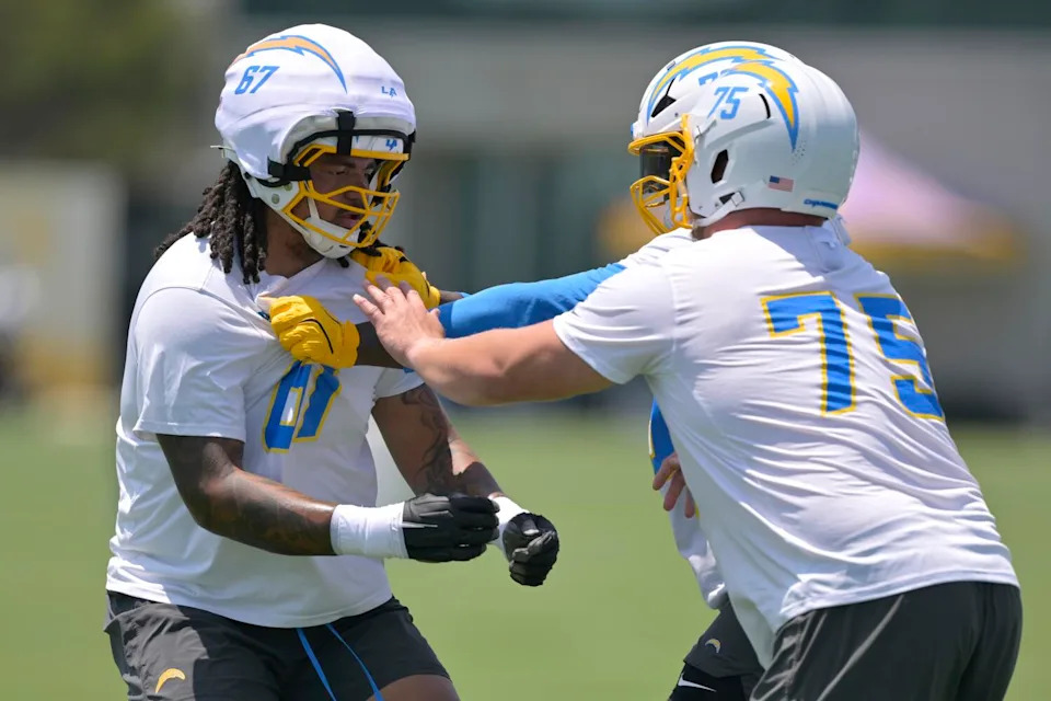 Chargers offensive linemen Savion Washington, left, Mekhi Becton and center Bradley Bozeman (75) participate in drills.