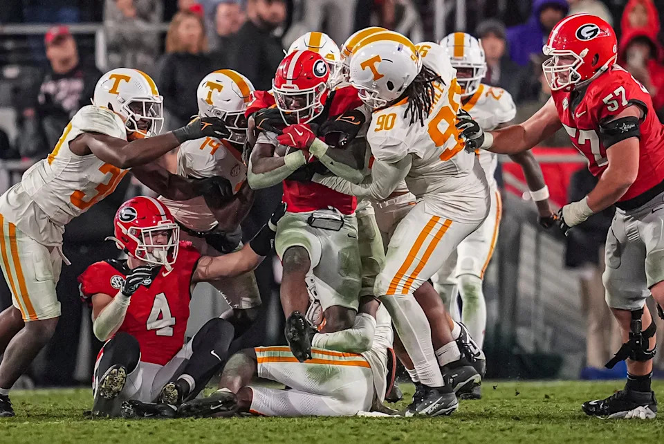 Nov 16, 2024; Athens, Georgia, USA; Georgia Bulldogs running back Nate Frazier (3) protects the ball from Tennessee Volunteers defensive lineman Dominic Bailey (90) during the second half at Sanford Stadium. Mandatory Credit: Dale Zanine-Imagn Images
