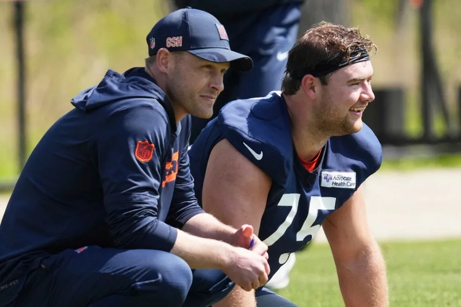 Chicago Bears head coach Ben Johnson, left, and offensive line Ozzy Trapilo watch during the NFL football team’s rookie camp in Lake Forest, Ill., Saturday, May 10, 2025. (AP Photo/Nam Y. Huh)