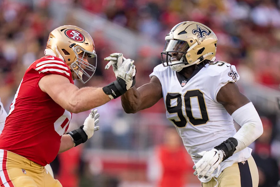 November 27, 2022; Santa Clara, California, USA; San Francisco 49ers offensive tackle Mike McGlinchey (69) against New Orleans Saints defensive end Tanoh Kpassagnon (90) during the second quarter at Levi's Stadium. Mandatory Credit: Kyle Terada-USA TODAY Sports