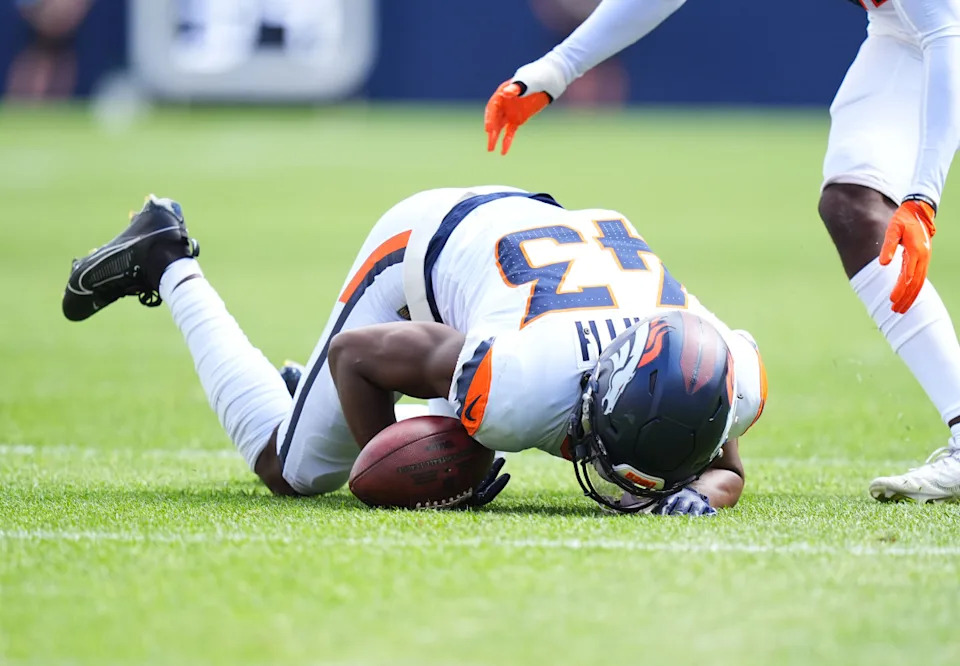 Denver Broncos safety Keidron Smith (43) recovers fumble in the second quarter against the Arizona Cardinals at Empower Field at Mile High.Ron Chenoy-Imagn Images