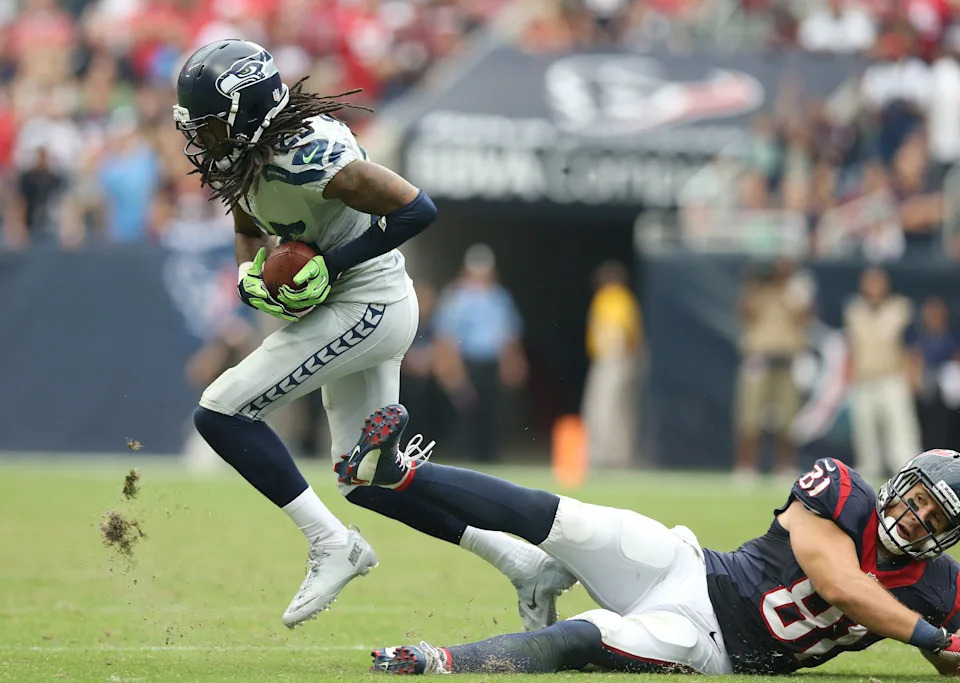 Sep 29, 2013; Houston, TX, USA; Seattle Seahawks cornerback Richard Sherman (25) intercepts the ball in the fourth quarter against Houston Texans tight end Owen Daniels (81) at Reliant Stadium. The Seattle Seahawks beat the Houston Texans 23-20. in overtime. Mandatory Credit: Matthew Emmons-USA TODAY Sports