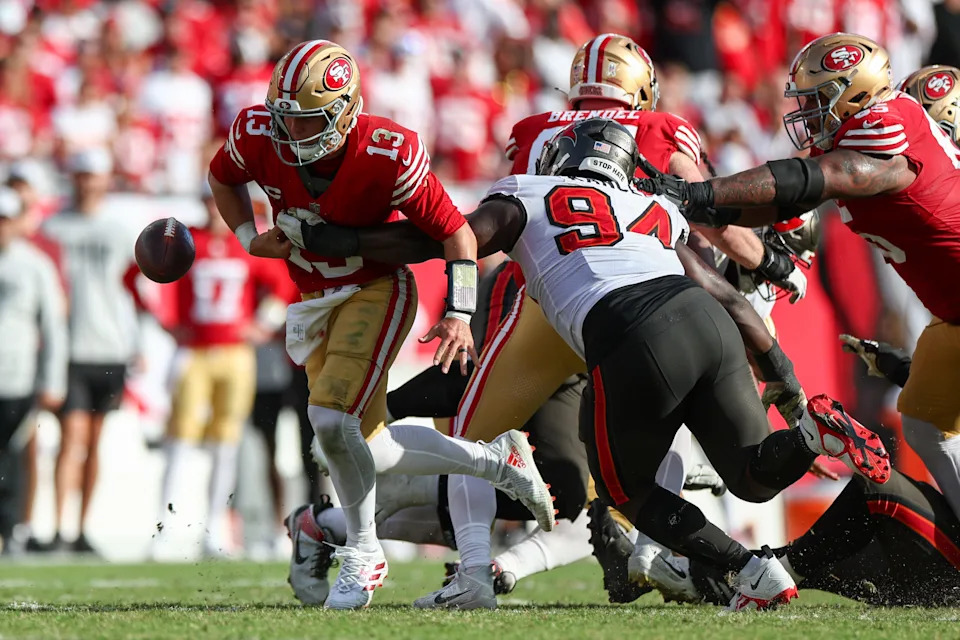 Nov 10, 2024; Tampa, Florida, USA; Tampa Bay Buccaneers defensive tackle Calijah Kancey (94) knocks th bell loose from San Francisco 49ers quarterback Brock Purdy (13) in the fourth quarter at Raymond James Stadium. Mandatory Credit: Nathan Ray Seebeck-Imagn Images
