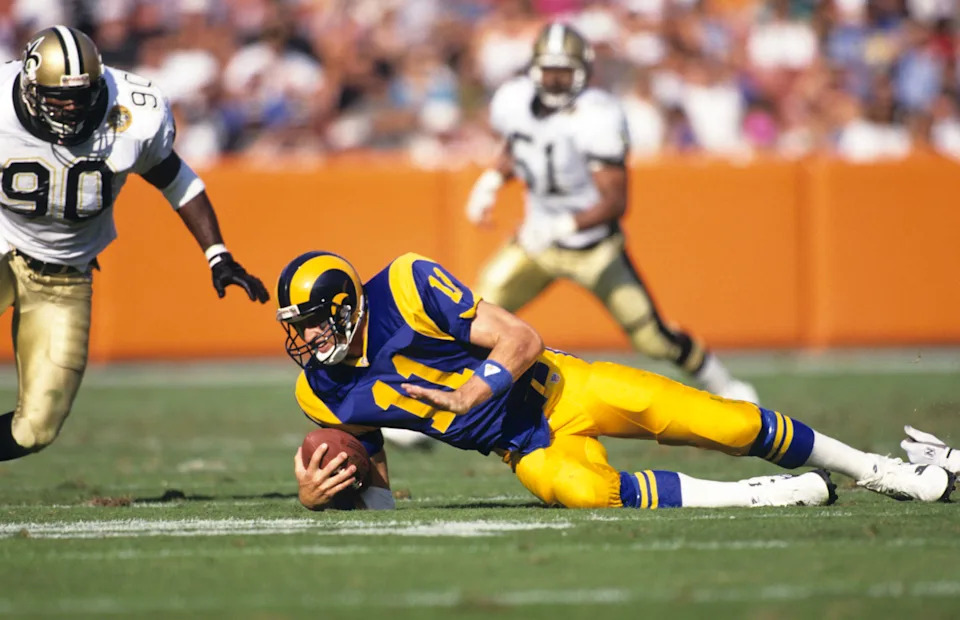 Nov 3, 1991; Anaheim, CA, USA; FILE PHOTO; Los Angeles Rams quarterback Jim Everett (11) hits the ground in front of New Orleans Saints linebacker James Williams (90) at Anaheim Stadium. Mandatory Credit: Peter Brouillet-USA TODAY NETWORK