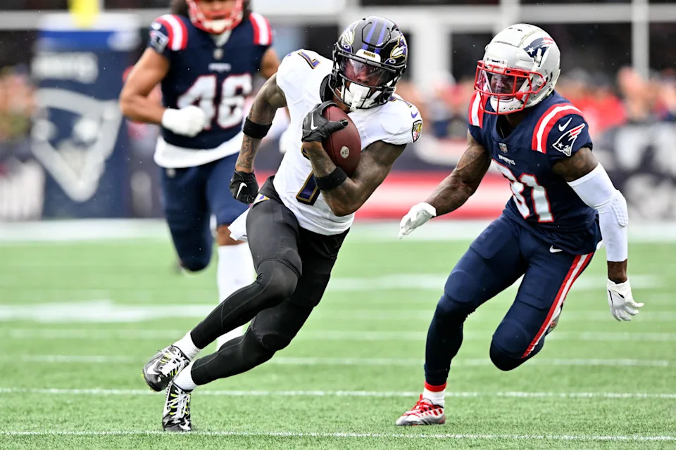 Baltimore Ravens wide receiver Rashod Bateman (7) runs with the ball in front of New England Patriots cornerback Jonathan Jones (31) during the second half at Gillette Stadium.Brian Fluharty-Imagn Images