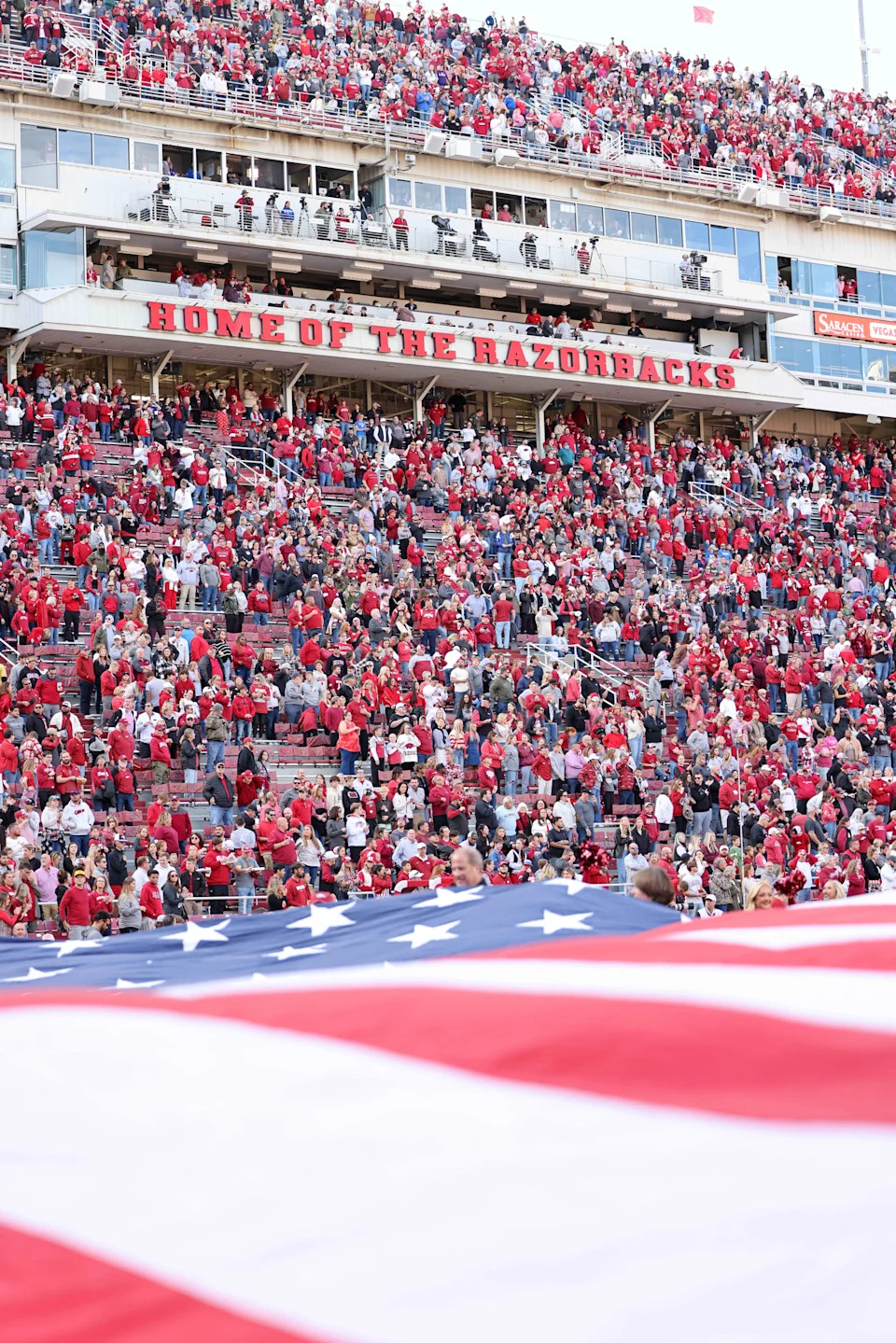 Nov 23, 2024; Fayetteville, Arkansas, USA; A flag is stretched across an end zone during the national anthem prior to a game between the Arkansas Razorbacks and Louisiana Tech Bulldogs at Donald W. Reynolds Razorback Stadium. Mandatory Credit: Nelson Chenault-Imagn Images