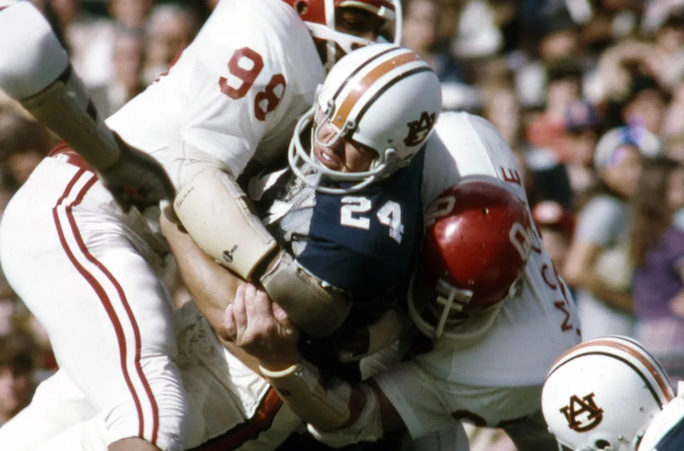 Jan 1, 1972, New Orleans, LA, USA; FILE PHOTO; Oklahoma Sooners defensive lineman Lucious Selmon (98) and Derland Moore (97) tackle Auburn Tigers running back Tommy Lowry (24) during the 1972 Sugar Bowl at Tulane Stadium. The Sooners defeated the Tigers 40-22. Mandatory Credit: Malcolm Emmons-USA TODAY Sports