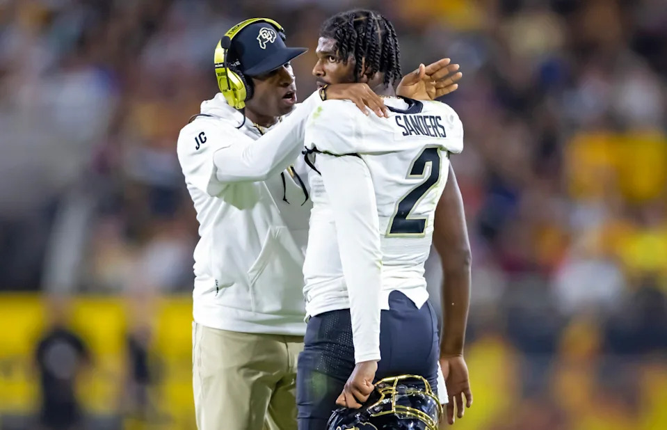 Colorado Buffaloes head coach Deion Sanders with son and quarterback Shedeur Sanders (2) against the Arizona State Sun Devils at Mountain America Stadium.Mark J. Rebilas-Imagn Images