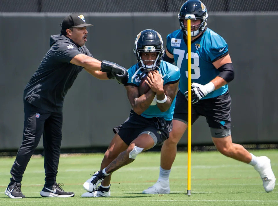 Jacksonville Jaguars wide receiver Dyami Brown (5) runs drill while being pursued by Jacksonville Jaguars center Robert Hainsey (73) during the fourth organized team activity at the Miller Electric Center in Jacksonville, Fla. Tuesday, May 27, 2025. [Doug Engle/Florida Times-Union]