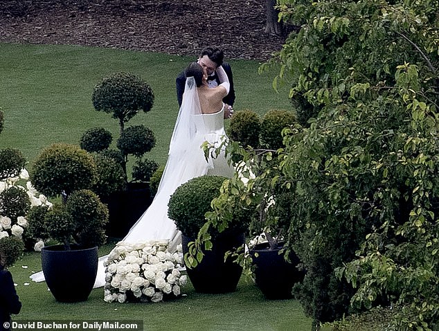 The couple were seen celebrating saying ‘I do’ with a kiss in front of a clapping crowd of guests