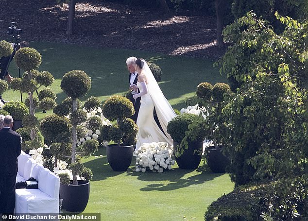 The actress accessorized her gown with full-length white gloves, large diamond studs and a frothy veil