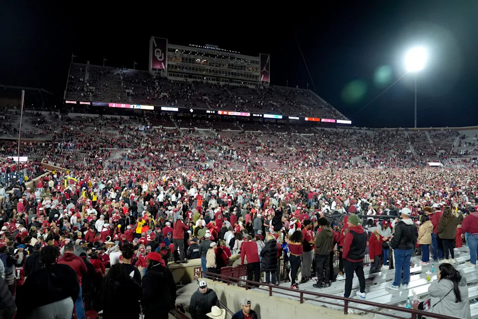 Fans rush the field after a college football game between the University of Oklahoma Sooners (OU) and the Alabama Crimson Tide at Gaylord Family - Oklahoma Memorial Stadium in Norman, Okla., Saturday, Nov. 23, 2024. Oklahoma won 24-3.
