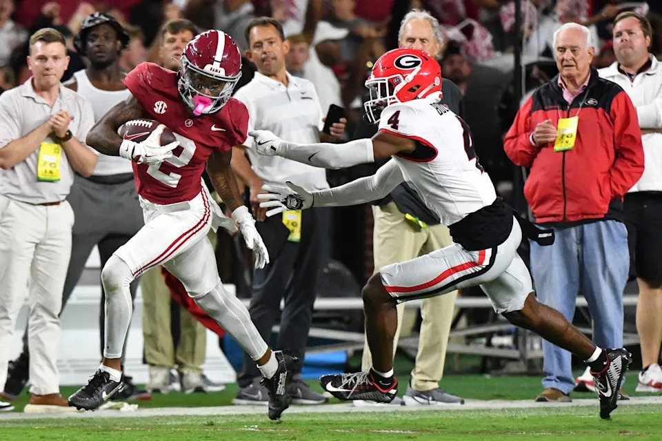 Sep 28, 2024; Tuscaloosa, Alabama, USA; Alabama Crimson Tide wide receiver Ryan Williams (2) breaks a tackle by Georgia Bulldogs defensive back KJ Bolden (4) to score a touchdown that put Alabama ahead in the fourth quarter at Bryant-Denny Stadium. Alabama defeated Georgia 41-34. Mandatory Credit: Gary Cosby Jr.-Imagn Images