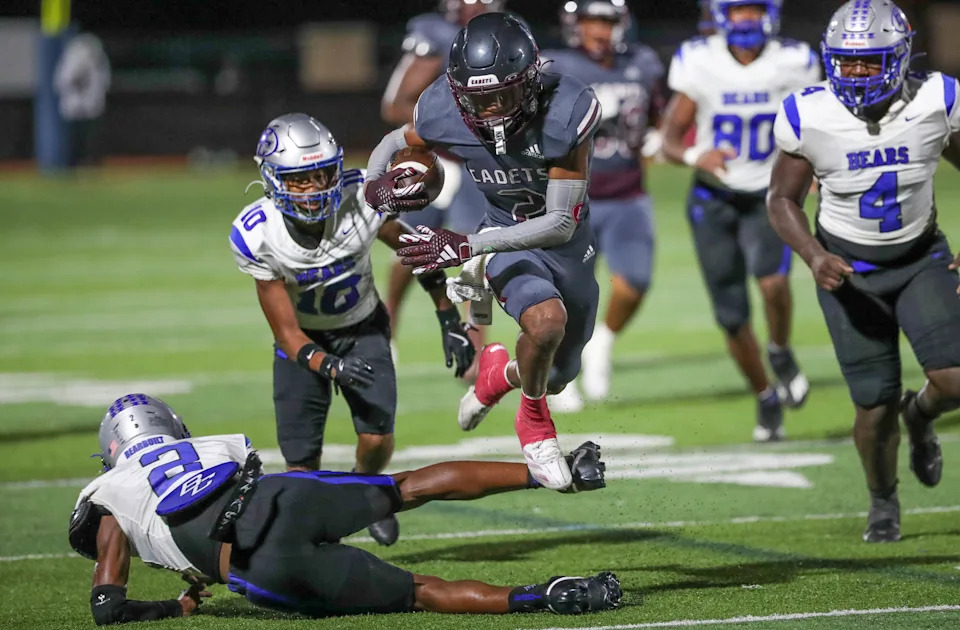 Benedictine's Micah Williams leaps over a Burke County defender as he races to the end zone on Friday, August 30, 2024 at Memorial Stadium.